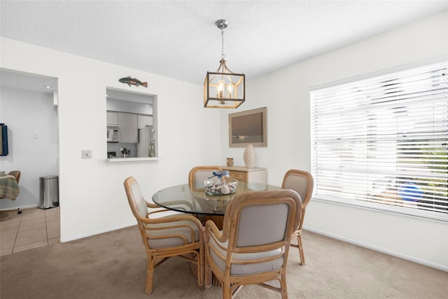 605 Apple Ln, Englewood, FL 34223 - tiled dining area featuring a chandelier and carpet flooring