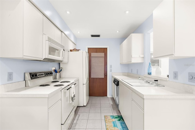 605 Apple Ln, Englewood, FL 34223 - kitchen with white appliances, light countertops, white cabinetry, light tile patterned floors, and recessed lighting