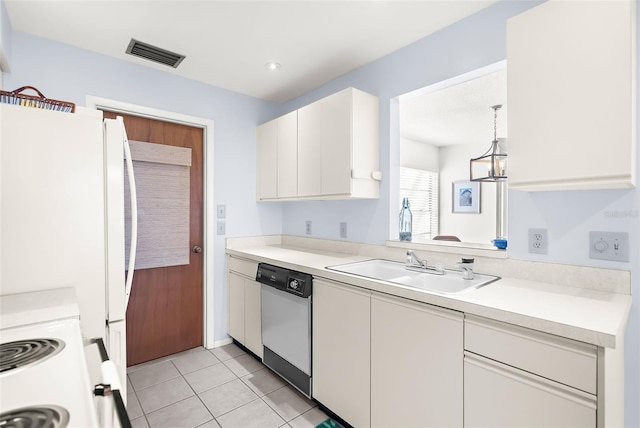 605 Apple Ln, Englewood, FL 34223 - kitchen featuring white appliances, light tile patterned floors, white cabinetry, and light countertops
