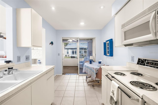 kitchen with sink, ceiling fan, light tile patterned floors, white appliances, and white cabinets