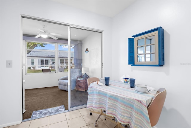 sitting room featuring light tile patterned flooring and ceiling fan