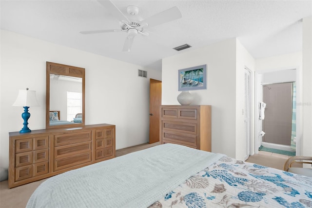 605 Apple Ln, Englewood, FL 34223 - bedroom featuring a ceiling fan, ensuite bath, and light colored carpet