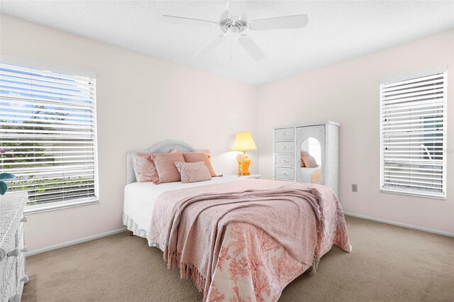 bedroom with light colored carpet and ceiling fan