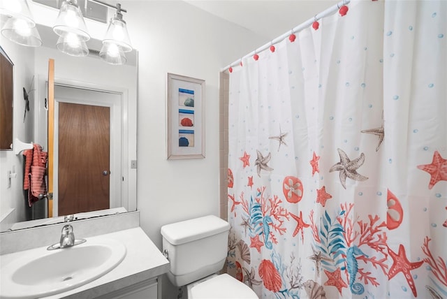 bathroom featuring curtained shower, vanity, toilet, and a notable chandelier