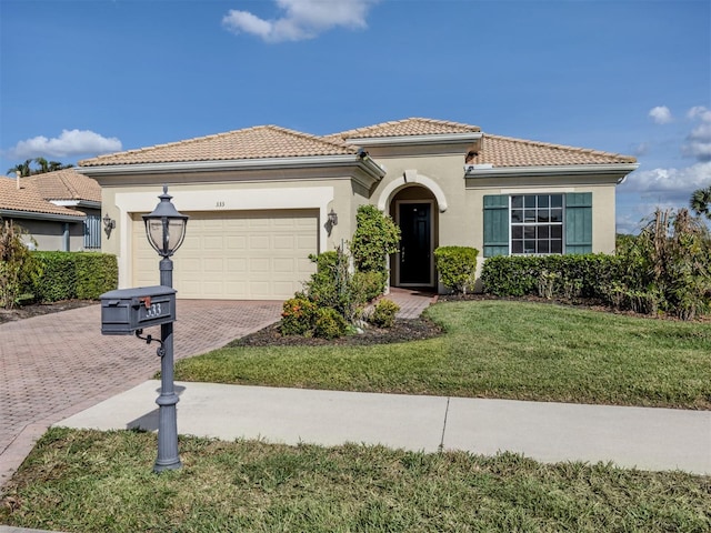 mediterranean / spanish home with a front lawn and a garage