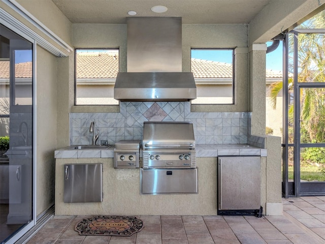 view of patio / terrace with sink, area for grilling, and exterior kitchen