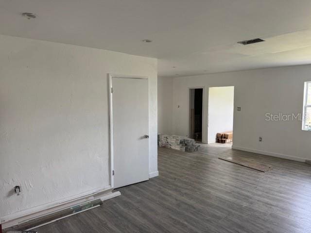 unfurnished room featuring dark hardwood / wood-style floors