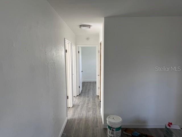 corridor with wood-type flooring