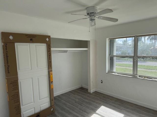 unfurnished bedroom with a closet, hardwood / wood-style floors, and ceiling fan