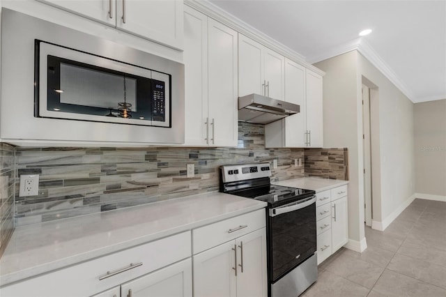 kitchen featuring crown molding, white cabinets, light tile patterned floors, and appliances with stainless steel finishes