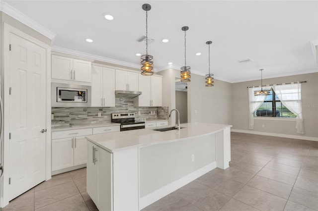 kitchen with appliances with stainless steel finishes, a center island with sink, white cabinetry, and sink