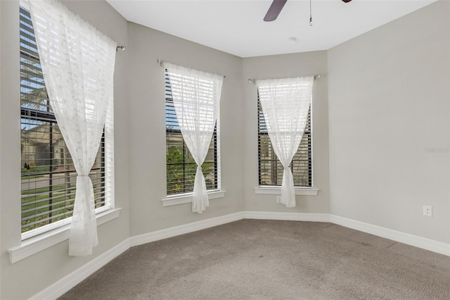 spare room featuring carpet flooring, ceiling fan, and plenty of natural light