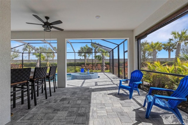 sunroom with ceiling fan and a wealth of natural light