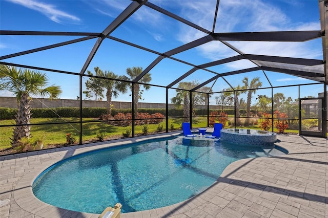 view of swimming pool featuring glass enclosure, an in ground hot tub, and a patio area