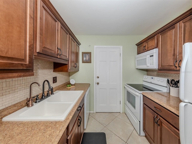 kitchen featuring backsplash, white appliances, sink, and light tile patterned floors