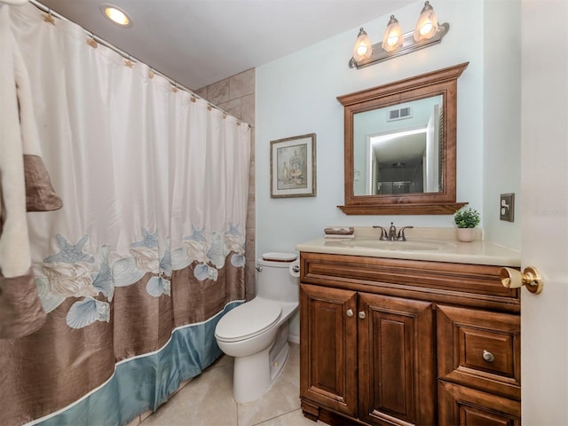 bathroom with toilet, vanity, tile patterned flooring, and walk in shower