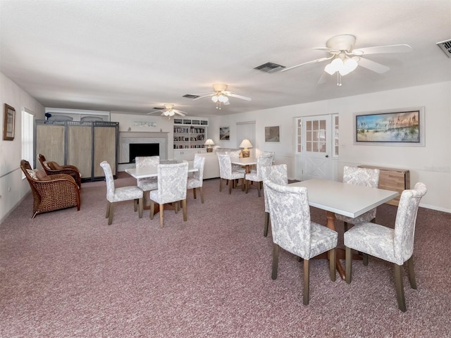 dining room featuring ceiling fan, a textured ceiling, and carpet flooring