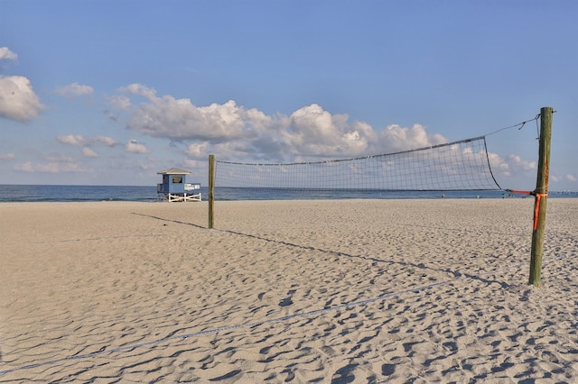 view of home's community featuring a view of the beach, volleyball court, and a water view