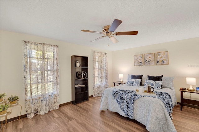 bedroom featuring light wood-type flooring and ceiling fan