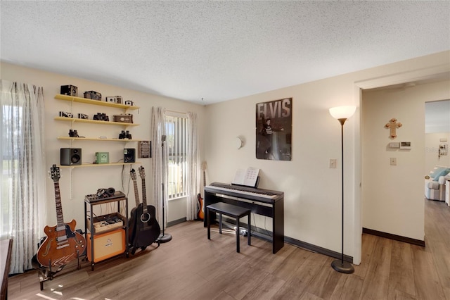 miscellaneous room with a textured ceiling and hardwood / wood-style flooring