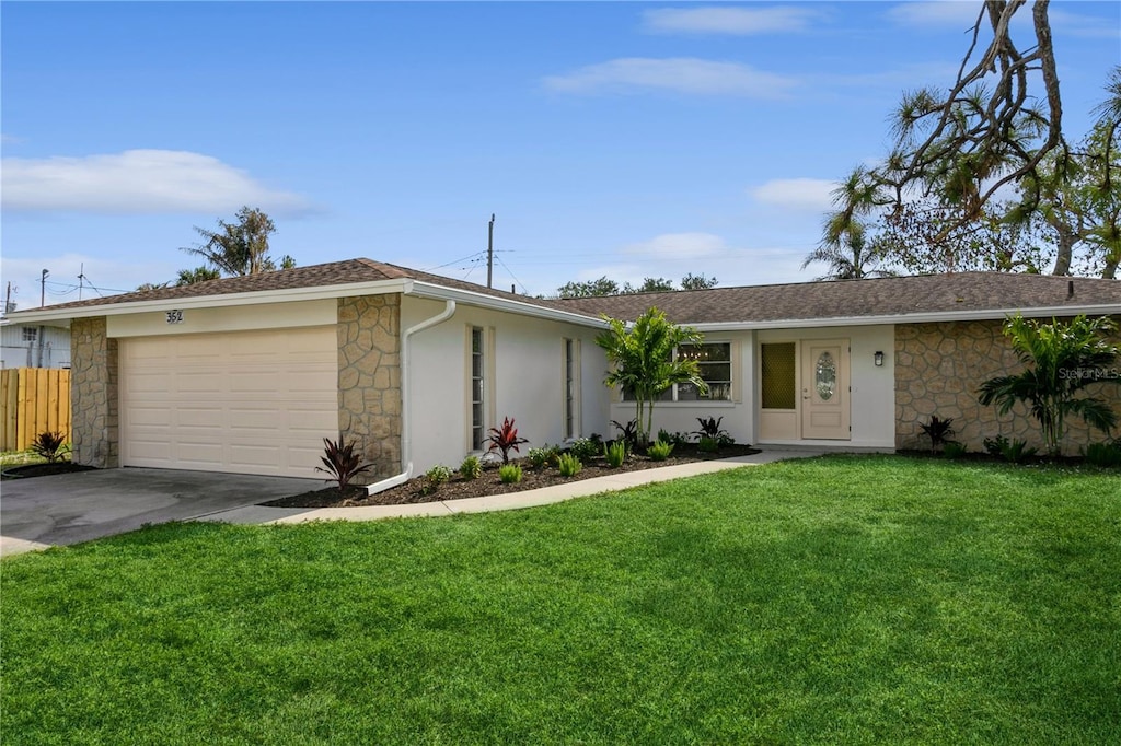 ranch-style house featuring a front yard and a garage