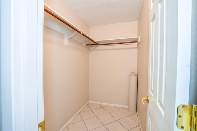 walk in closet featuring light tile patterned floors