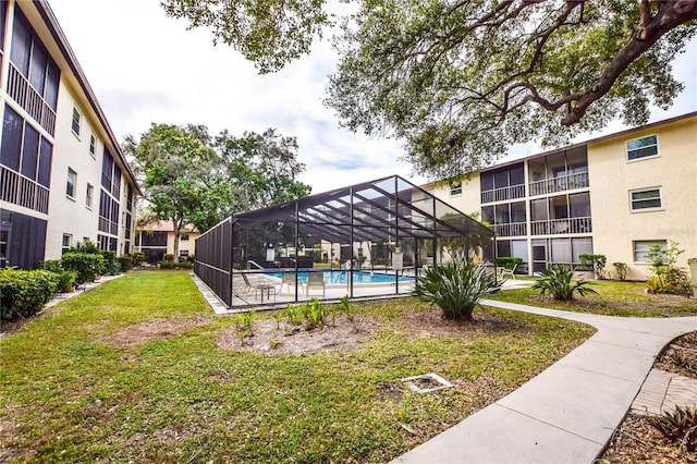 view of property's community featuring a lawn and a swimming pool