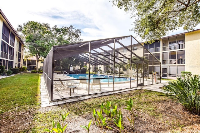 view of swimming pool with a lanai and a patio area