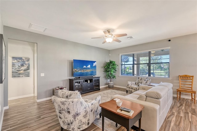 living room featuring light wood-type flooring and ceiling fan