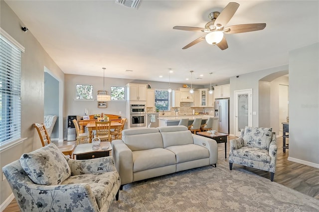 living room featuring ceiling fan and wood-type flooring