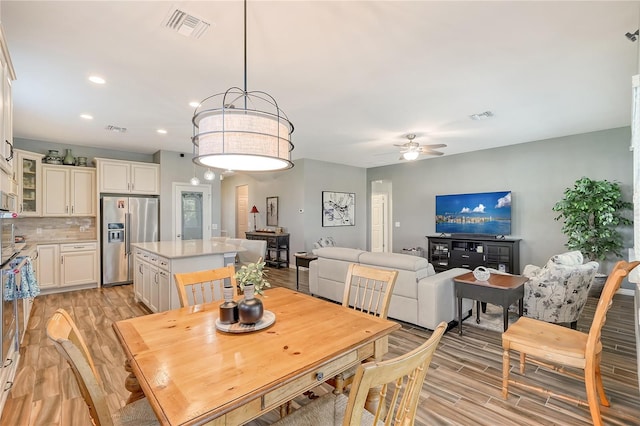 dining area featuring ceiling fan and light hardwood / wood-style flooring