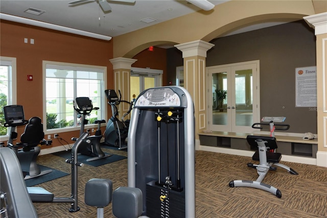 exercise room with dark carpet, french doors, ornate columns, and ceiling fan