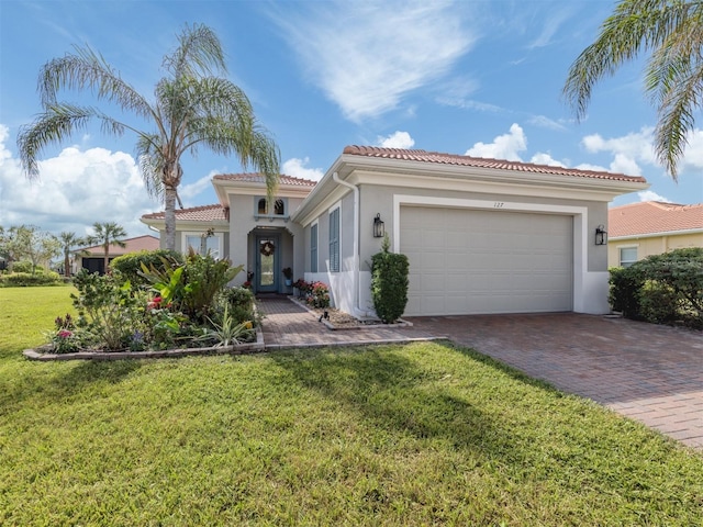 mediterranean / spanish house with a garage and a front yard