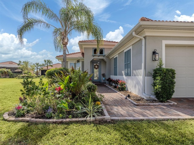 view of front facade with a front yard and a garage