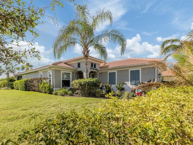 mediterranean / spanish-style house featuring a front yard