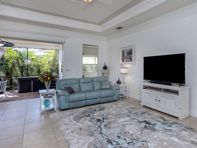 tiled living room featuring ceiling fan and crown molding