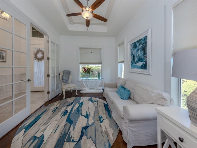 sitting room featuring a raised ceiling, ceiling fan, and hardwood / wood-style floors