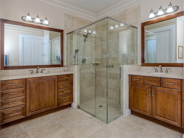 bathroom with tile patterned flooring, vanity, and walk in shower