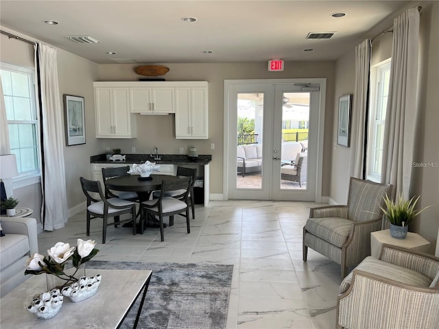 dining area with marble finish floor, baseboards, visible vents, and french doors