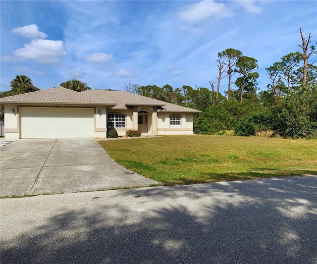 view of front of house featuring a garage and a front lawn