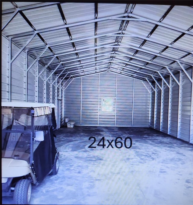 miscellaneous room featuring concrete floors and vaulted ceiling