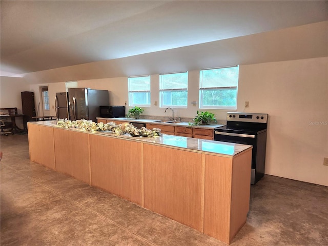 kitchen featuring sink, a kitchen island, and appliances with stainless steel finishes