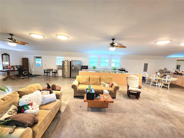 living room with plenty of natural light and ceiling fan