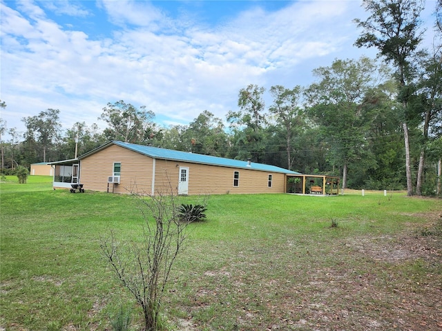 exterior space featuring a yard and a sunroom