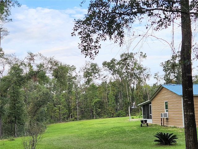 view of yard with cooling unit and a sunroom