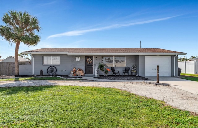 single story home featuring a garage and a front lawn