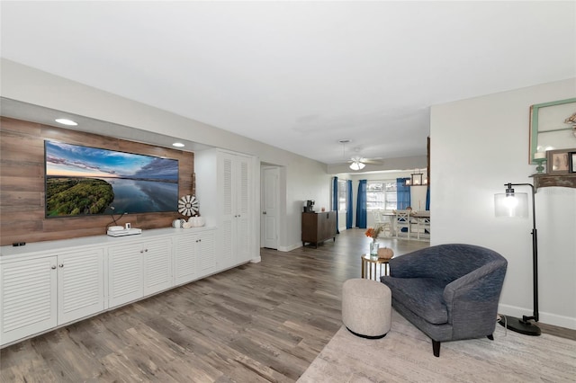 sitting room featuring hardwood / wood-style flooring and ceiling fan