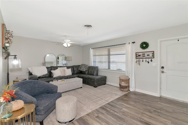 living room featuring hardwood / wood-style flooring and ceiling fan