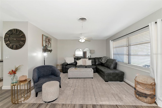 living room featuring ceiling fan and light hardwood / wood-style floors