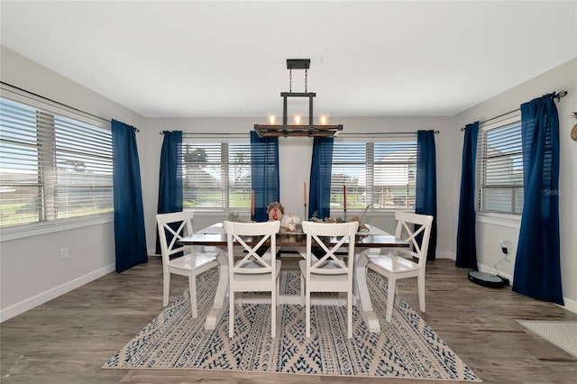 dining room with hardwood / wood-style flooring and a chandelier